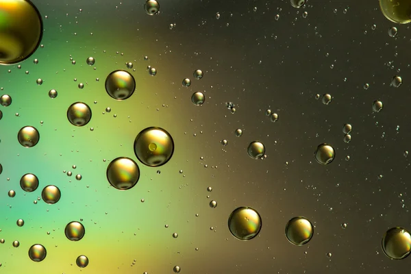 Oil and water abstract in gold and brown, with a rainbow effect — Stock Photo, Image