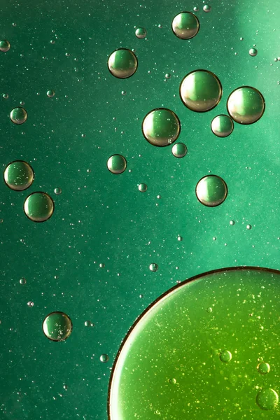 Oil and water abstract in greens and gold — Stock Photo, Image
