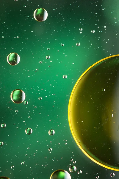 Oil and water abstract in yellow, green and gold — Stock Photo, Image