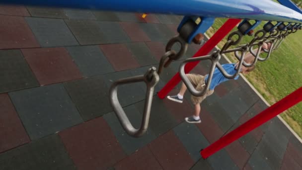 Boy climbing at playground — Stock Video