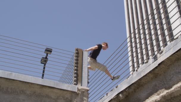 Runners vault over parking garage obstacle — Stock Footage Runners vault over parking garage obstacle Stock Video