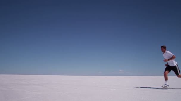 Athlete running at salt flats — Stock Video