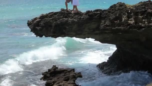 Пара на скале с видом на океан — стоковое видео