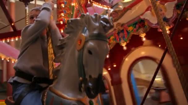 Boy riding on carousel — Stock Video