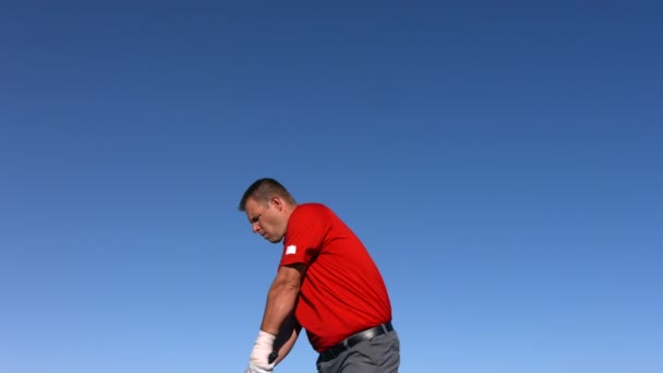 Golfspelare tee off i himlen — Stockvideo