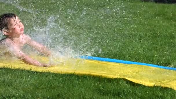 Boy on water slide — Stock Video