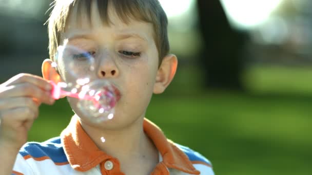 Boy blowing bubbles — Stock Video