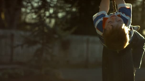 Boy spinning on tire swing — Stock Video