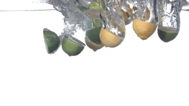 Citroenen en limoenen spatten in water — Stockvideo