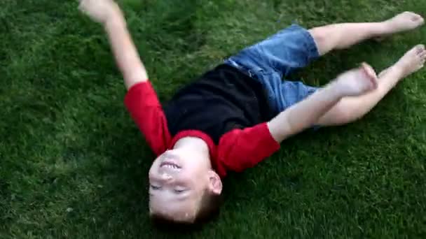 Boy rolling on grass — Stock Video