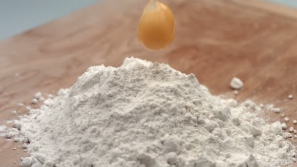 Egg dropping into flour — Stock Video
