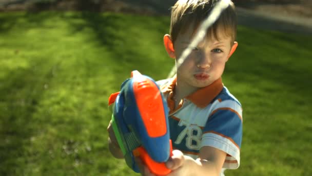 Хлопчик обприскує шприц-пістолет — стокове відео