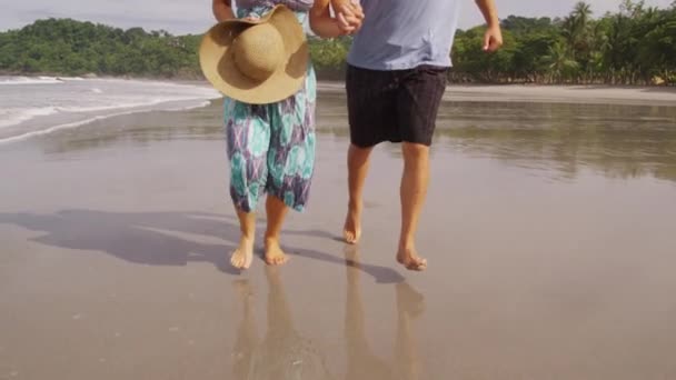 Пара бегущих по пляжу — стоковое видео