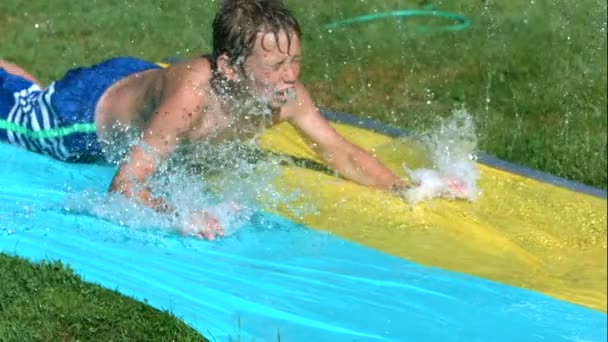 Young boy on water slide — Stock Video