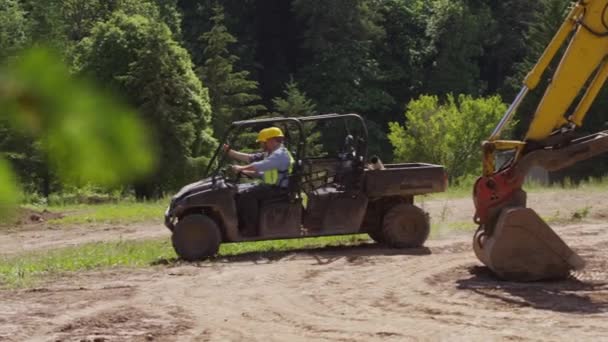 Workers driving utility vehicle — Stock Video