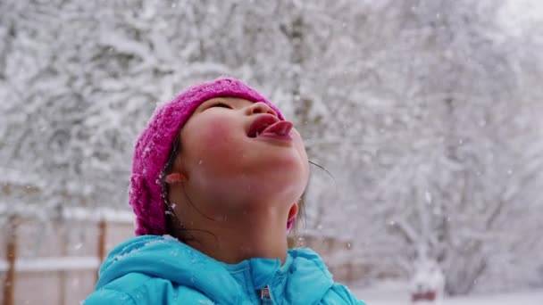 Girl catching snow flakes — Stock Video