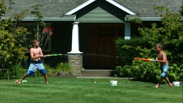 Boys having squirt gun fight — Stock Video