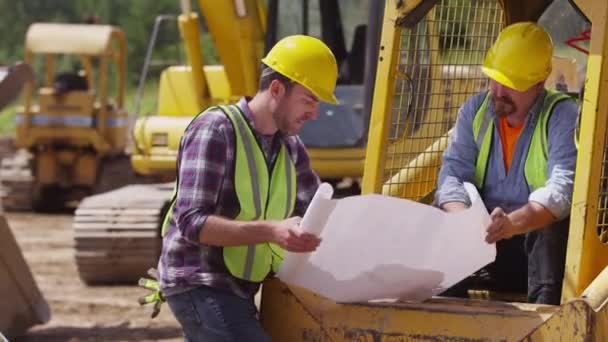 Trabalhadores que examinam planos — Vídeo de Stock