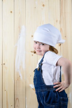 Küçük kız bir ahşap duvar boyaları