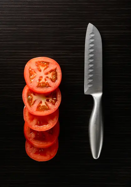 Cut tomato and cucumber with a knife — Stock Photo, Image