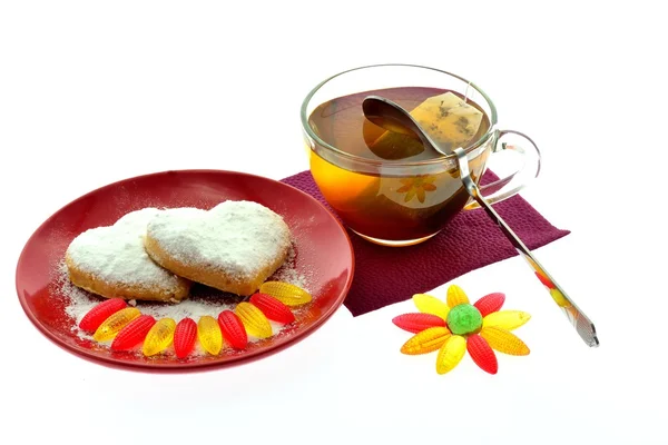 Biscotti su un disco rosso e una tazza di tè nero — Foto Stock
