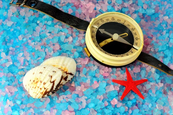 Shells, star and tourist compass on sea salt — Stock Photo, Image