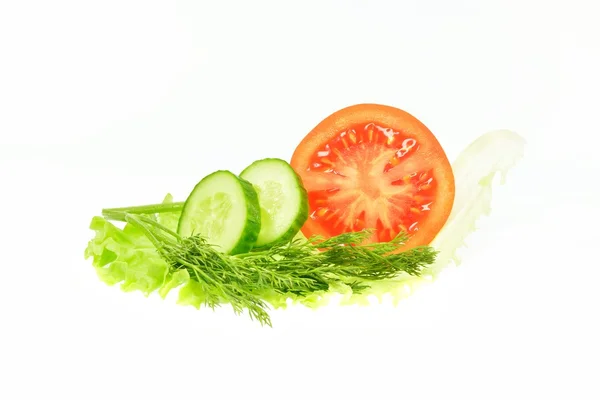 Slice cucumber dill tomato half on a piece of lettuce — Stock Photo, Image