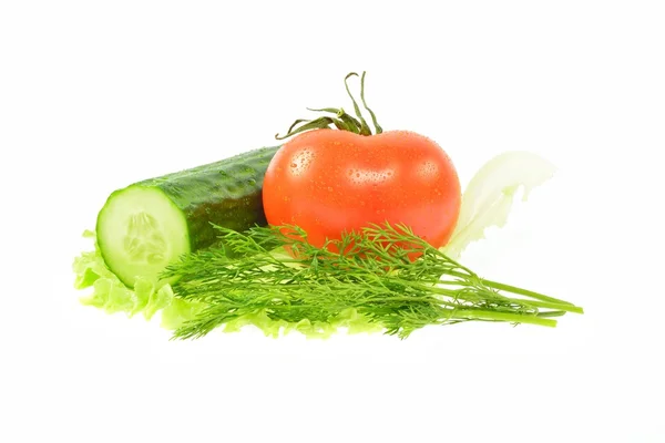 Half a cucumber, tomato, dill on piece of lettuce — Stock Photo, Image