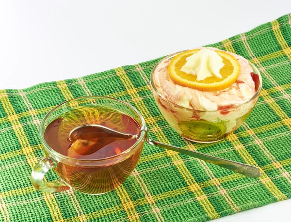 Milk dessert with orange and kiwi on a napkin — Stock Photo, Image