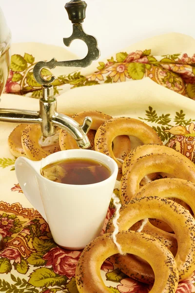 Related bagels with poppy and tea — Stock Photo, Image