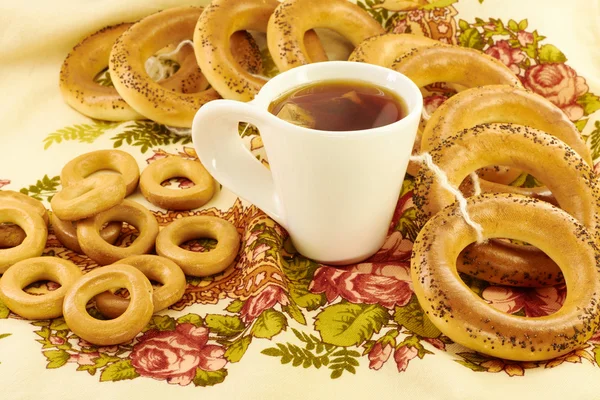 Related bagels with poppy and tea — Stock Photo, Image