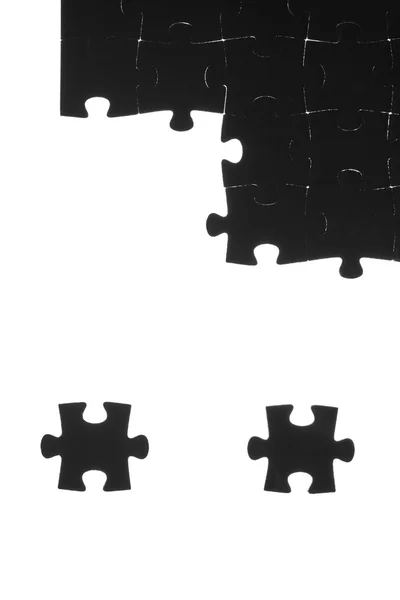 Zwarte puzzel op een witte achtergrond — Stockfoto