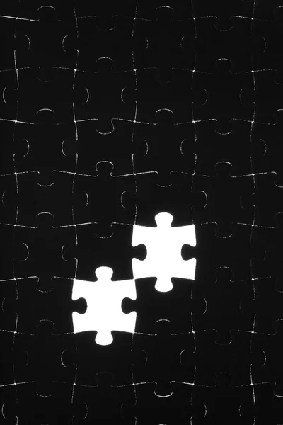 Zwarte puzzel op een witte achtergrond — Stockfoto
