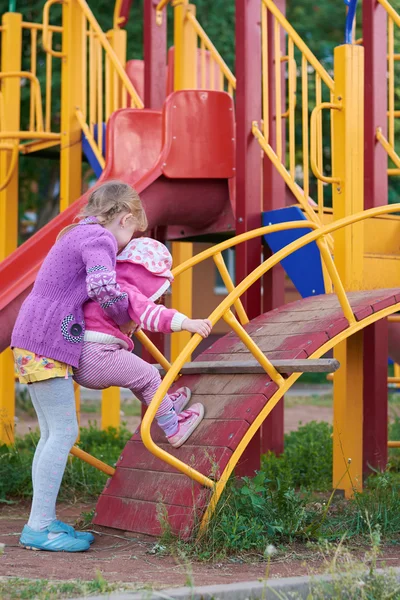 Two girls are playing on the playground — Stock Photo, Image