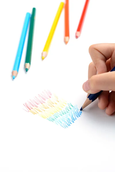 Girl paints a rainbow of colored pencils — Stock Photo, Image