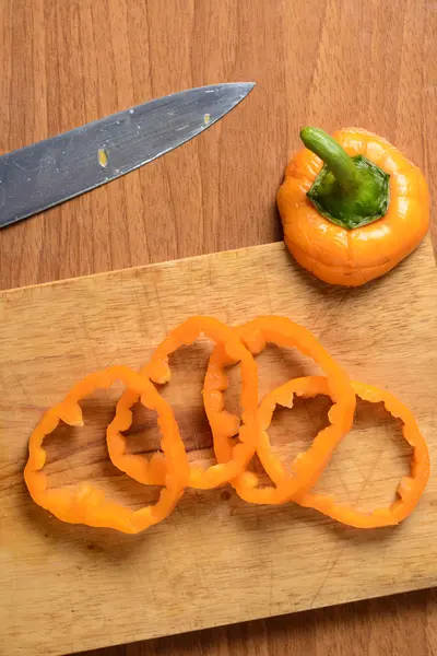 Cut peppers on a wooden board — Stock Photo, Image