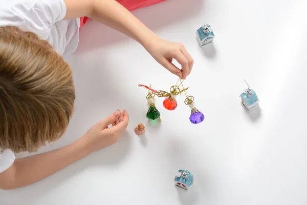 Girl playing with Christmas decorations — Stock Photo, Image