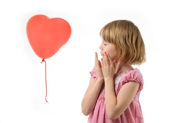 Little girl in pink dress holding a balloon — Stock Photo, Image