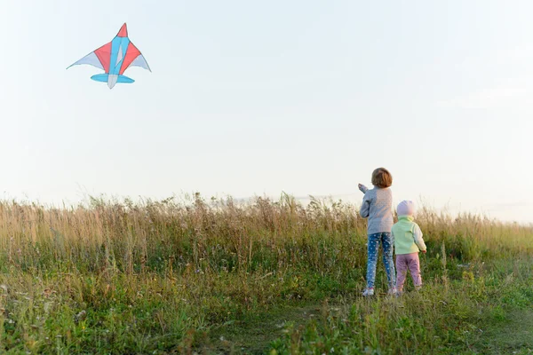 Girls playing with a kite — Stock Photo, Image