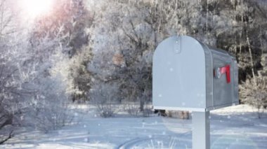 Mailbox with a Christmas greeting card on the background of a winter forest