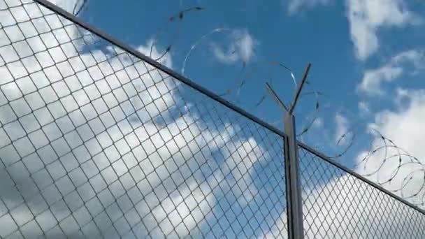 Barbed wire chain link fence against skyline timelapse at the restricted area – Stock-video