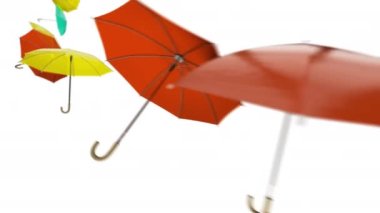 Kırmızı sarı şemsiyeli turuncu şemsiyeler rüzgarla havada uçuşuyor.