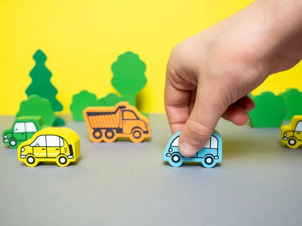 wooden cars on a yellow-gray background