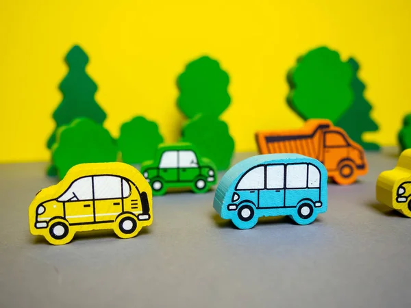 wooden cars on a yellow-gray background