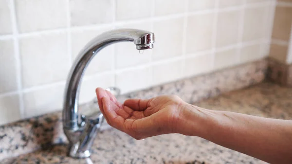 woman\'s hands opening the fountain.Middle aged woman hands and water shortage.Climate crisis.