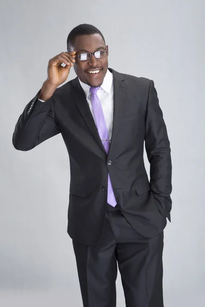 Young smiling businessman posing with eyeglasses — Stock Photo, Image