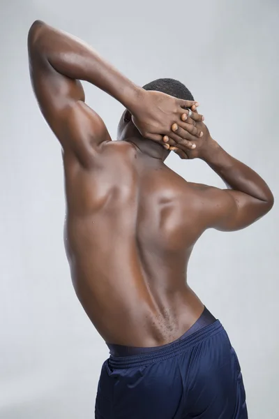 Young sportsman shows his back — Stock Photo, Image