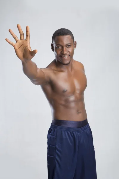 Young sportsman reaching out on to camera — Stock Photo, Image