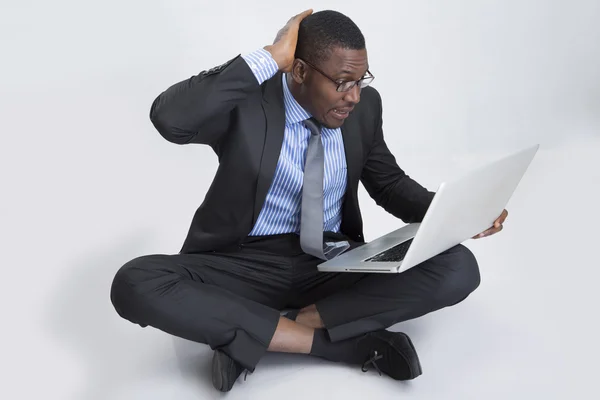 Jovem empresário sentado com laptop — Fotografia de Stock