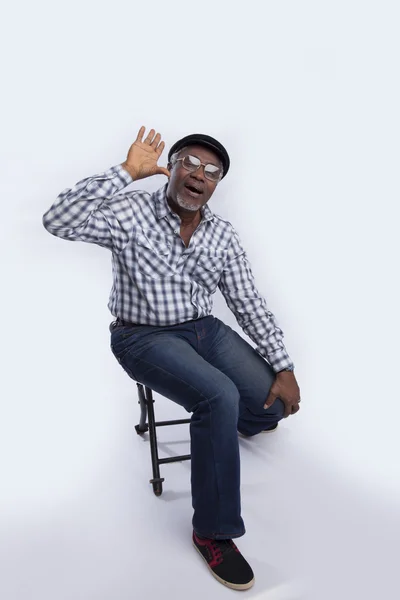 Strong man sitting on chair — Stock Photo, Image